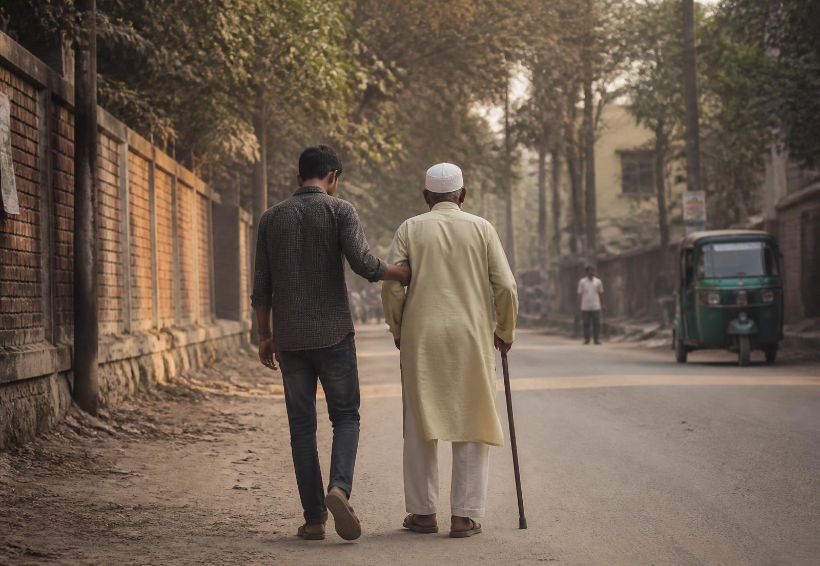 Two people walking together along a quiet street in the late afternoon